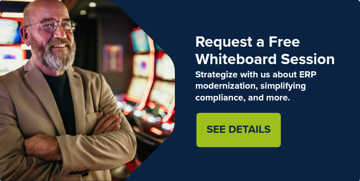man-in-business-suit-smiling-in-casino-with-gaming-tables-and-slot-machines_CTA