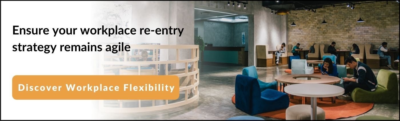 people sitting on low couches around a table inside a coworking space